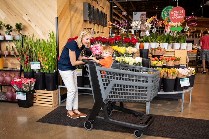 Shopper in store with Bemis Manufacturing cart
