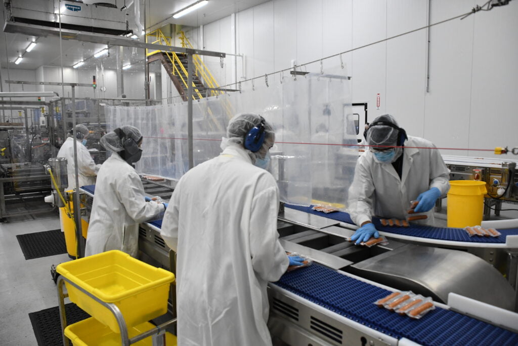 Salm workers packaging meat