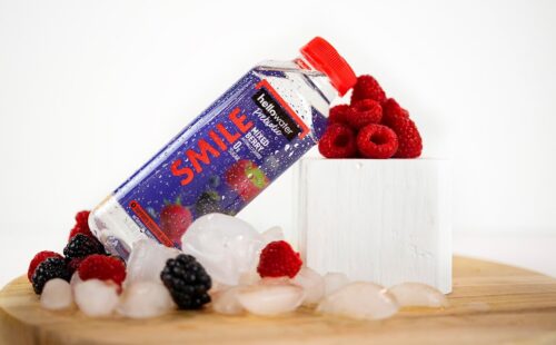 Bottle of Hellowater with berries and ice