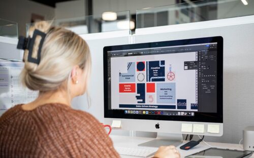 Graphic designer working at desk on project